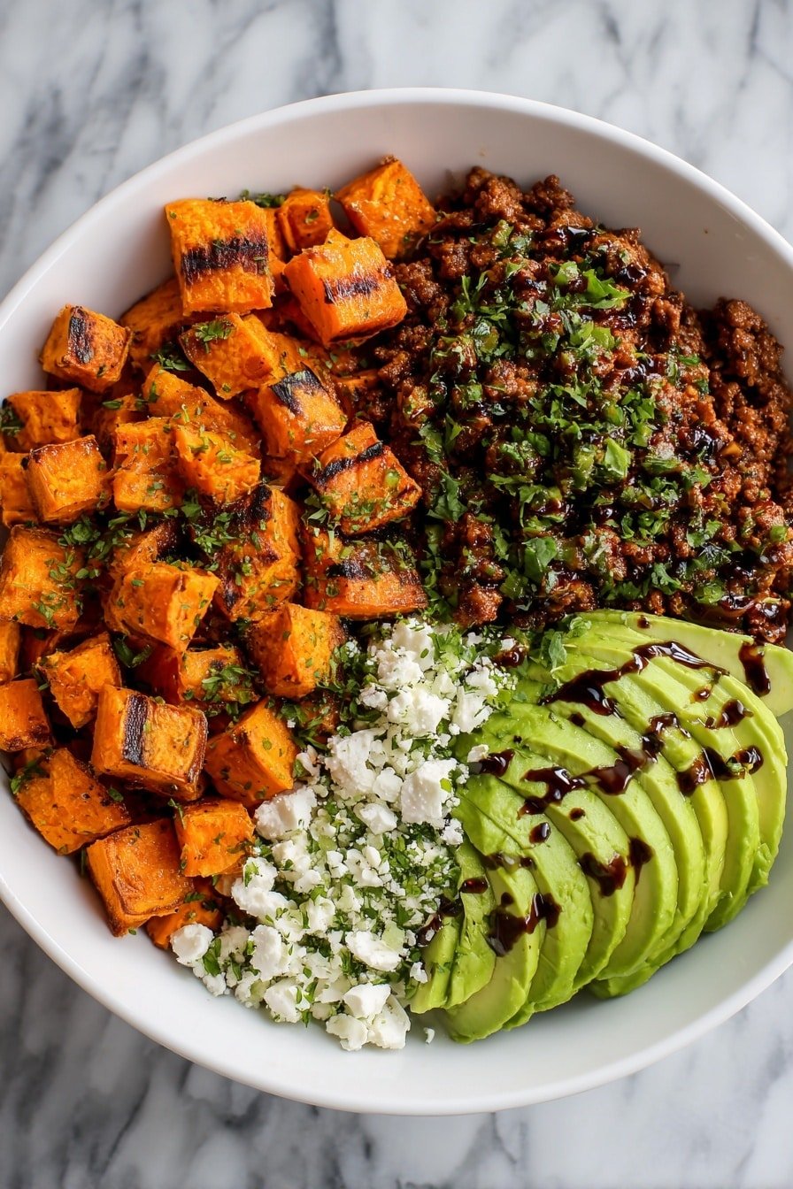 A white bowl filled with four main layers arranged side by side: bright orange roasted sweet potato cubes with char marks on the left, cooked dark brown minced meat topped with green herb bits on the upper right, smooth light green avocado slices drizzled with a dark sauce on the right, and white crumbled cheese sprinkled with green herbs on the bottom left. The bowl sits on a white marbled surface. photo taken with an iphone --ar 2:3 --v 7 - Sweet Potato Ground Beef Bowls with Hot Honey, savory sweet potato bowls, spicy honey beef meal, easy weeknight dinner recipes, hearty healthy bowls