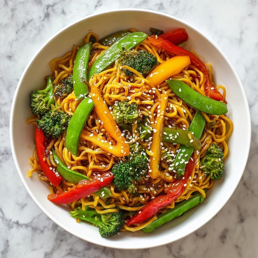A round white bowl filled with three main layers: the bottom layer consists of yellow stir-fried noodles with a shiny texture, mixed evenly throughout with thin orange and yellow bell pepper strips. On top of the noodles, there are bright green broccoli florets placed around the bowl, and large flat green sugar snap peas scattered in between. Red bell pepper strips are layered more on the top, contrasting with the green vegetables and yellow noodles, all coated lightly with a brown sauce and sprinkled with small white sesame seeds. The bowl is set on a white marbled surface. Photo taken with an iphone --ar 1:1 --v 7 - Vegetable Stir-Fry Noodles, quick vegetable stir-fry, healthy noodle stir-fry, easy veggie stir-fry, colorful vegetable noodles